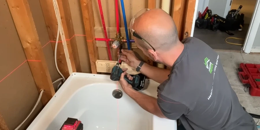 Plumber connecting a shower valve to new PEX supply lines