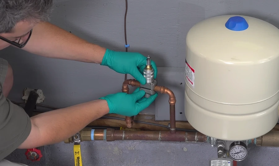 Plumber installing a shutoff valve on a copper water line